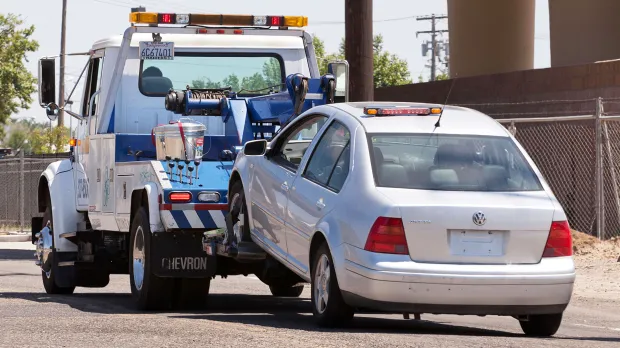 Car being towed by truck