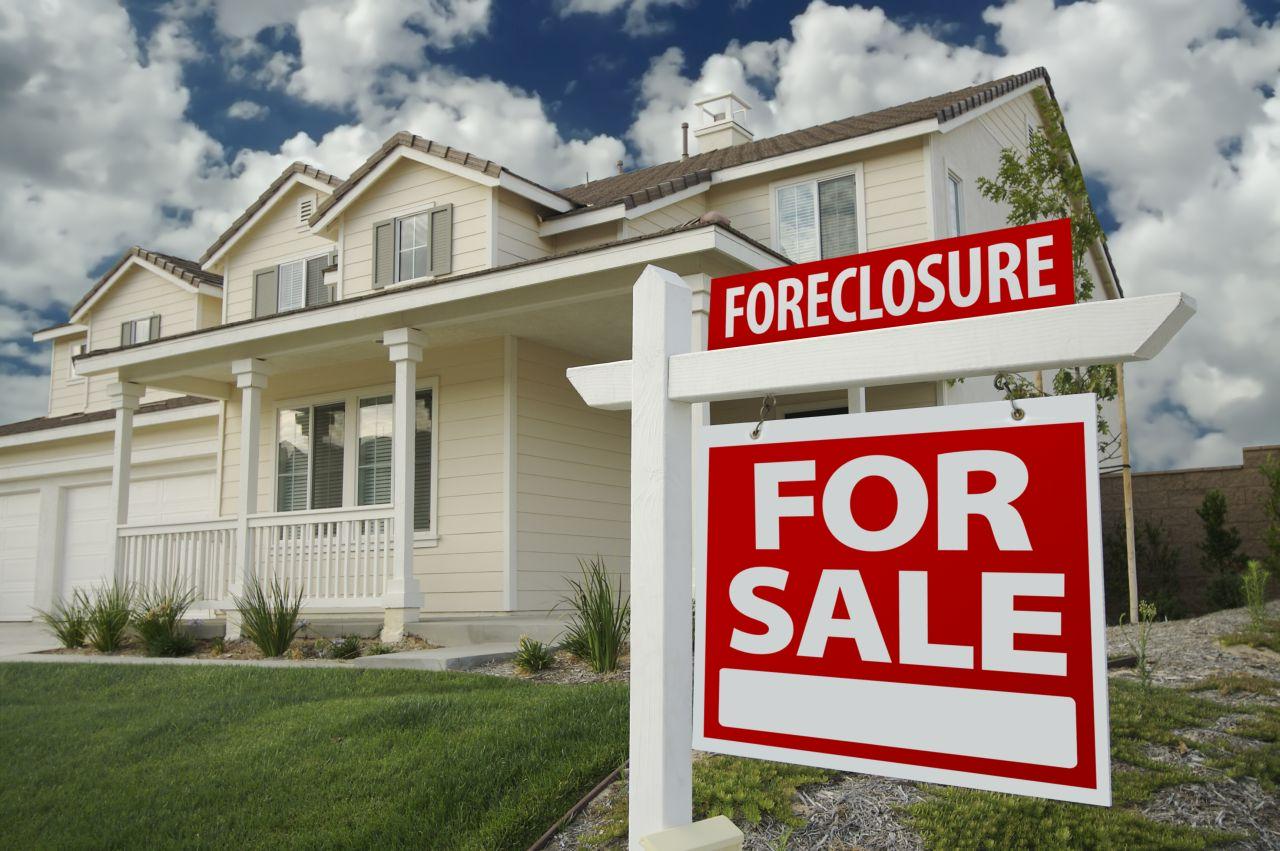 House with foreclosure sign